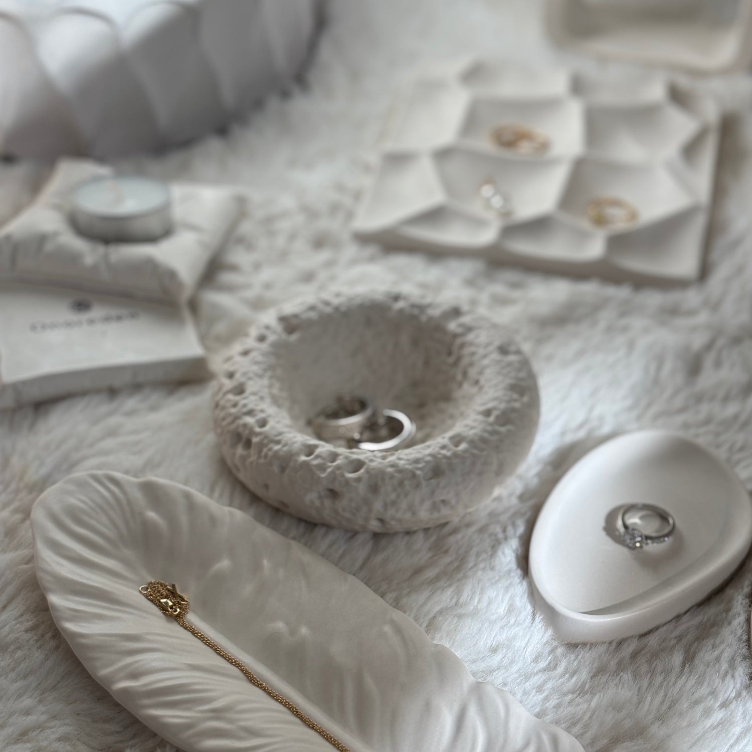 Minimalist sculptural tray styled with jewelry and accessories.
