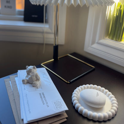 Halo handmade tray on dark wood table, styled with scent spray and geometric bear in soft window light